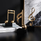 Estatuetas Decorativas de Notas Musicais em Resina Dourada